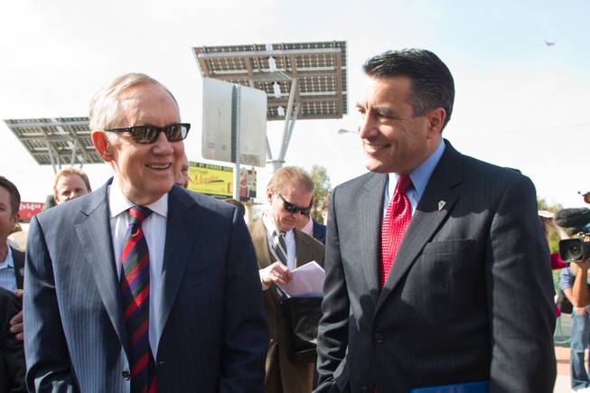 Senator Harry Reid and Governer Brian Sandoval share a laugh before meeting with the press to discuss clean energy investment in Nevada Thursday, March 20, 2014.