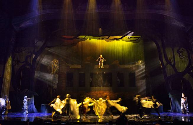 The Seeker stands in the rain over dancers during the One Night for ONE DROP dress rehearsal from the Michael Jackson ONE Theatre at Mandalay Bay on Thursday, March 20, 2014.