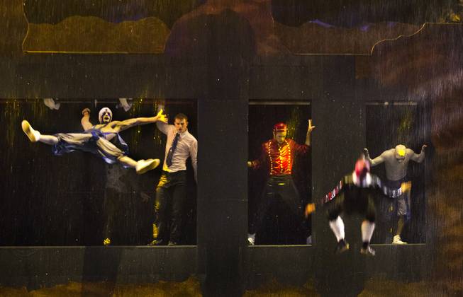 Trampoline artists leap in the rain during the One Night for ONE DROP dress rehearsal from the Michael Jackson ONE Theatre at Mandalay Bay on Thursday, March 20, 2014.