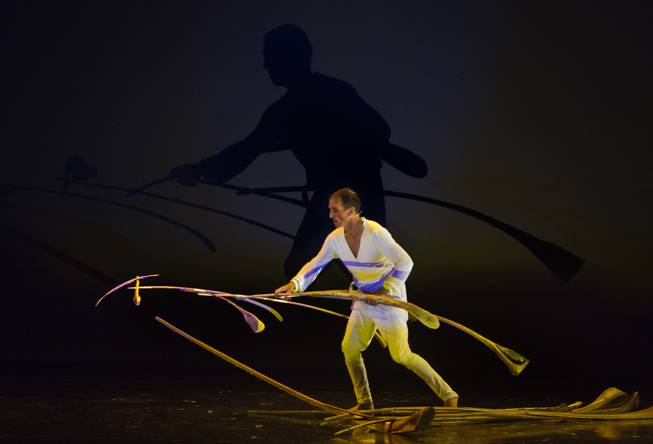 A performer balances sticks during the One Night for ONE DROP dress rehearsal in the Michael Jackson ONE Theatre on Thursday, March 20, 2014.