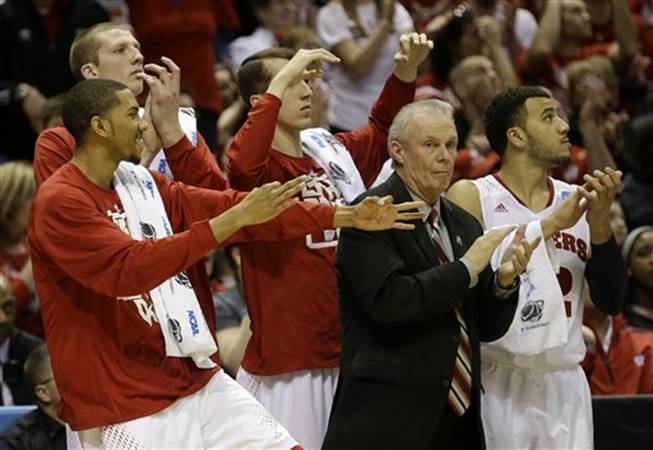 Wisconsin head coach Bo Ryan and players on the bench react after a three-pointer by Wisconsin guard Ben Brust during the second half of a second-round game in the NCAA basketball tournament Thursday, March 20, 2014, in Milwaukee.