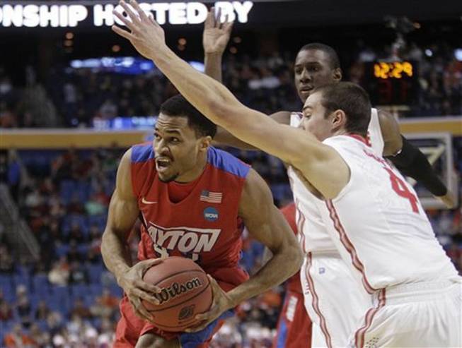 Dayton's Vee Sanford (43) drives past Ohio State's Aaron Craft (4) during the first half of a second-round game in the NCAA college basketball tournament Thursday, March 20, 2014, in Buffalo, N.Y.