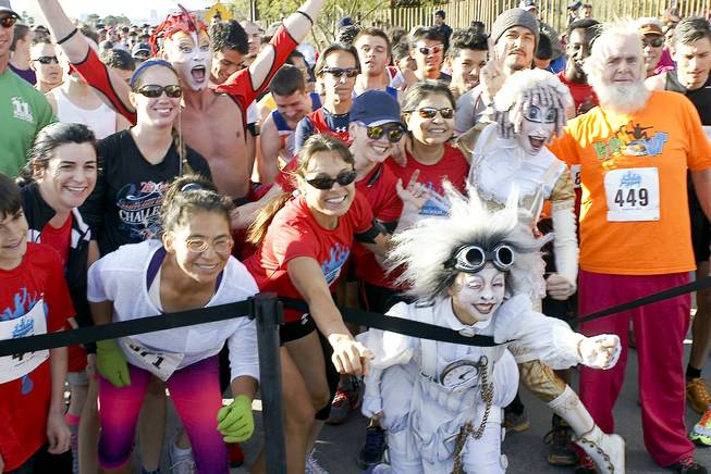 Participants pose for a photo with Cirque du Soleil performers at the Run Away with Cirque du Soleil 5K Run and One-Mile Fun Walk at the Springs Preserve on Saturday, March 15, 2014.