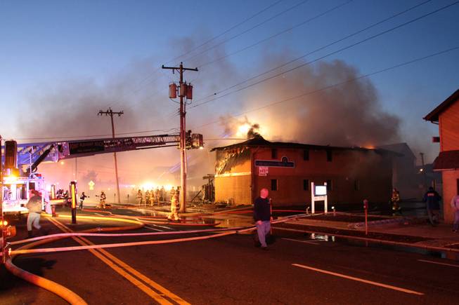Firefighters work to put out a fire at  Mariner's Cove Inn  in Point Pleasant Beach, N.J. early Friday, March 21, 2014. 
