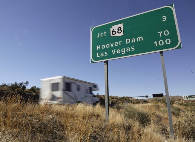 In this Friday, Nov. 8, 2013, photo, motorists head northbound on U.S. Highway 93, in Kingman, Ariz. Las Vegas and Phoenix are linked by U.S. 93, a road that narrows to two lanes and, until recently, backed up traffic over the Hoover Dam. Despite being two of the largest cities in the Southwest, they’re the only major metropolitan areas in the U.S. that aren’t directly connected by an interstate freeway.