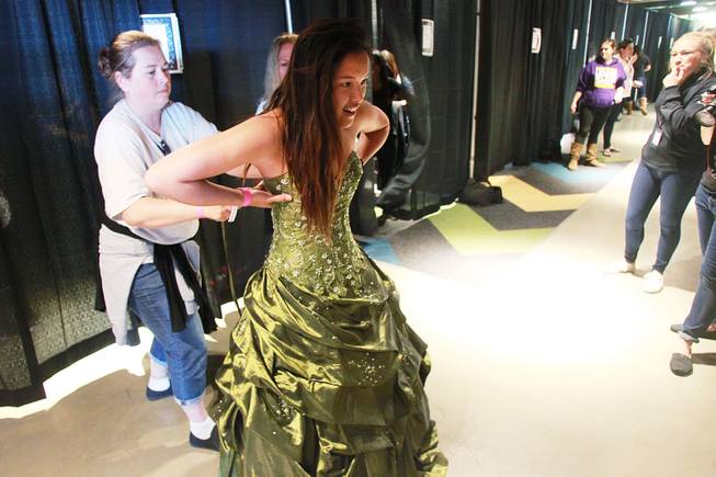 Tracy Ingram helps Kristal Nguyen from Clark High try on a dress during Las Vegas Prom Closet's "Operation Glass Slipper" Saturday, March 22, 2014.