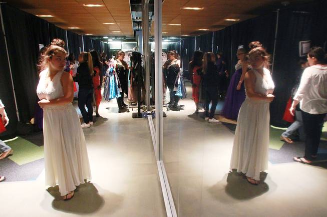 Young women try on dresses during Las Vegas Prom Closet's "Operation Glass Slipper" Saturday, March 22, 2014.