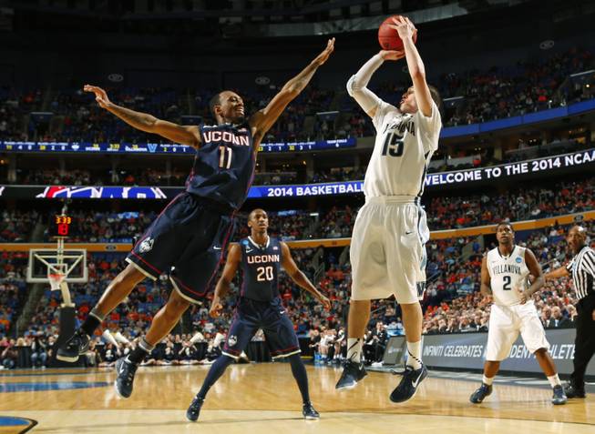 Villanova's Ryan Arcidiacono (15) shoots over Connecticut's Ryan Boatright (11) during the first half of a third-round game in the NCAA men's college basketball tournament Saturday, March 22, 2014, in Buffalo, N.Y.