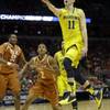 Michigan guard Nik Stauskas drives to the basket during the first half of a third-round game against Texas in the NCAA college basketball tournament Saturday, March 22, 2014, in Milwaukee.