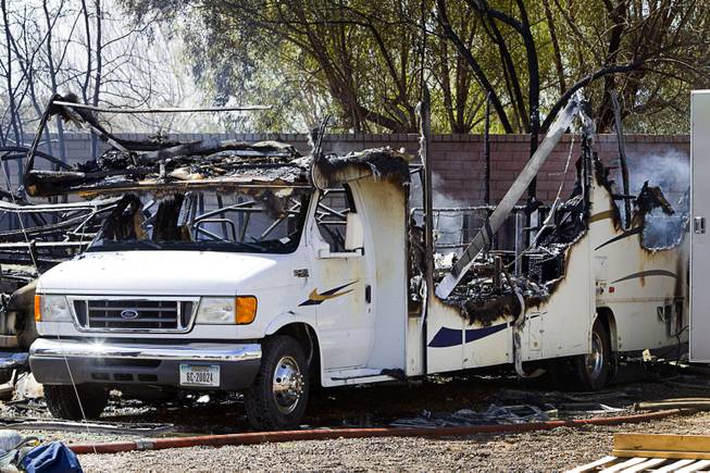 A destroyed recreational vehicle is shown after a fire near East Windmill Avenue and Bermuda Road Sunday, March 23, 2014. Homeowner Gary Baxter said he and others were working in the backyard when they noticed smoke coming from a smaller RV (left of the pictured RV). They tried to move the larger RV but it had been sitting unused for a while and the battery was dead. Two RV's, a shed and a trailer were destroyed but there were no injuries reported.
