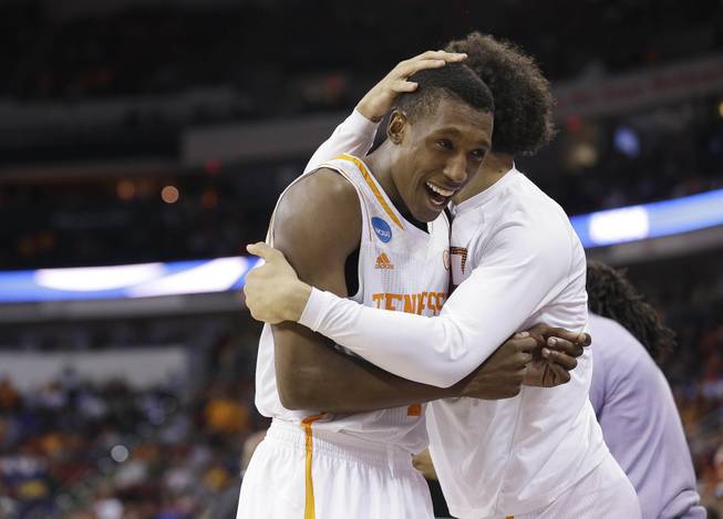 Tennessee guard Josh Richardson (1) embraces a teammate after the second half of an NCAA college basketball third-round tournament game against Mercer, Sunday, March 23, 2014, in Raleigh. Tennessee Won 83-63.