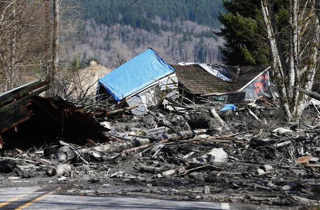 A house is seen destroyed in the mud on Highway 530 next to mile marker 37 on Sunday, March 23, 2014, the day after a giant landslide occurred near mile marker 37 near Oso, Washington.  