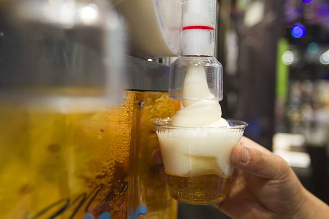Mimi Icy Beer Foam covers a beer during the Nightclub & Bar Convention and Trade Show at the Las Vegas Convention Center Wednesday March 26, 2014. The icy foam keeps the beer cold longer.