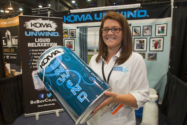 Laura Davis holds an oversized can of Koma Unwind relaxation drink during the Nightclub & Bar Convention and Trade Show at the Las Vegas Convention Center Wednesday March 26, 2014.