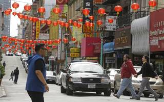 San Francisco police patrol the Chinatown district Thursday, March 27, 2014, in San Francisco.