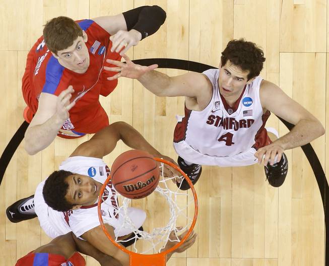 Stanford center Stefan Nastic (4) and Dayton forward/center Matt Kavanaugh (35) vie for a loose ball during the first half in a regional semifinal game at the NCAA college basketball tournament, Thursday, March 27, 2014, in Memphis, Tenn.
