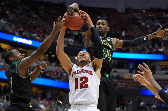 Wisconsin guard Traevon Jackson (12) competes against Baylor forward Cory Jefferson (34) for a rebound during the second half of an NCAA men's college basketball tournament regional semifinal,Thursday, March 27, 2014, in Anaheim, Calif.