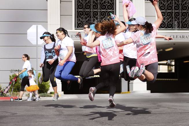 Participants jump in the air for a group photo during the 5k Bubble Run in downtown Las Vegas Saturday, March 29, 2014.