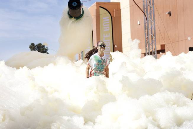 A participant goes through the yellow foam bog station during the 5k Bubble Run in downtown Las Vegas Saturday, March 29, 2014.