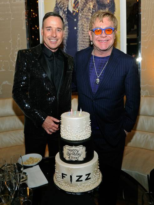 Sir Elton John, right, with David Furnish, celebrates his 67th ...