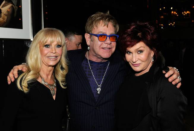 Sir Elton John, with Britt Eklund and Sharon Osbourne, celebrates ...