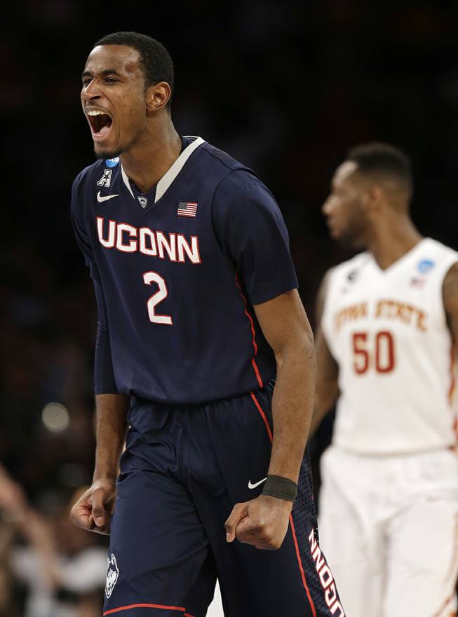 Connecticut's DeAndre Daniels exults during the second half in a regional semifinal of the NCAA men's college basketball tournament Friday, March 28, 2014 in New York. Iowa State's DeAndre Kane is at right. 
