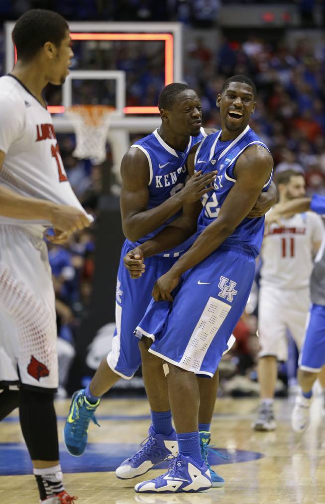 Kentucky's Alex Poythress (22) and Julius Randle celebrate after an NCAA Midwest Regional semifinal college basketball tournament game against the Louisville Saturday, March 29, 2014, in Indianapolis. Kentucky won 74-69. 