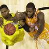 Michigan's Glenn Robinson III and Tennessee's Jeronne Maymon (34) go after a rebound during the first half of an NCAA Midwest Regional semifinal college basketball tournament game Friday, March 28, 2014, in Indianapolis. 