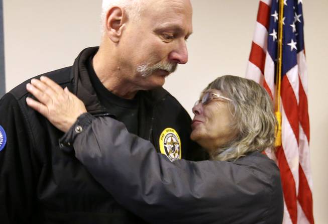  In this March 26, 2014, file photo, Robin Youngblood, right, smiles after embracing Snohomish County helicopter crew chief Randy Fay, who helped rescue her from the scene of a deadly mudslide days earlier, in Arlington, Wash. Youngblood was home when the mudslide hit, moving her house a quarter-mile before she was able to find her way out of the rubble.