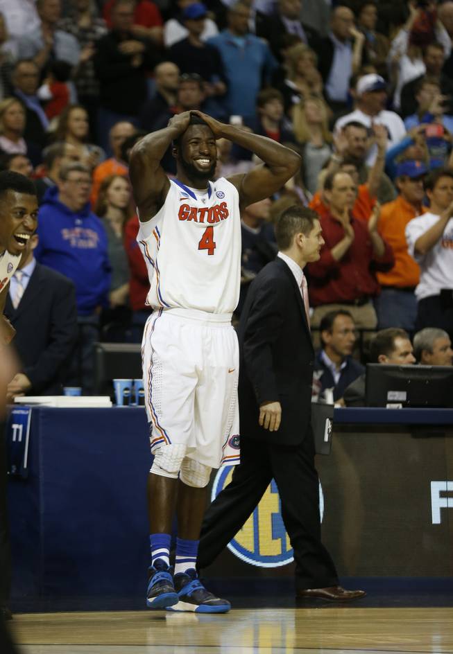 Florida center Patric Young (4) celebrates after the second half in a regional final game against Dayton at the NCAA college basketball tournament Saturday, March 29, 2014, in Memphis, Tenn. Florida won 62-52.