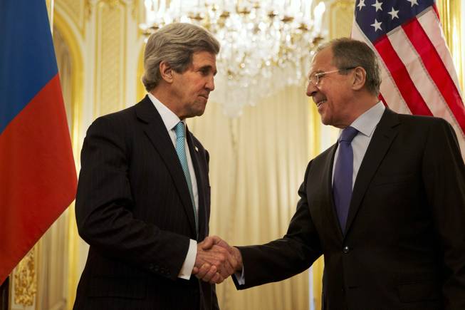 U.S. Secretary of State John Kerry, left, shakes hands with Russian Foreign Minister Sergey Lavrov before the start of their meeting at the Russian Ambassador's residence about the situation in Ukraine, in Paris Sunday March 30, 2014. Kerry traveled to Paris for a last minute meeting with Lavrov.