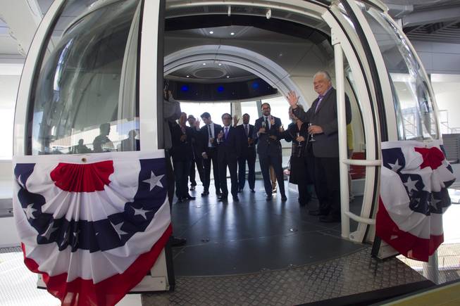 Special guests, executives and elected officials enter a cabin for the first official ride on the 550-foot-tall High Roller observation wheel Monday, March 31, 2014. Clark County Commission Chairman Steve Sisolak waves at right. The observation wheel, the tallest in the world, is part of the Linq project, a $550 million development by Caesars Entertainment Corp.
