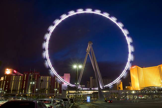 The 550-foot-tall High Roller observation wheel turns in the evening Monday, March 31, 2014. The observation wheel, the tallest in the world, is part of the Linq project, a $550 million development by Caesars Entertainment Corp.  The ride is now open to the public.