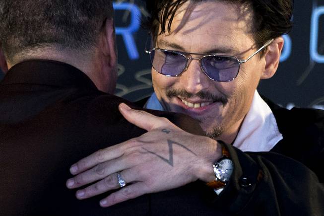  Johnny Depp, with a diamond ring on his left hand, attends a promotional event for his new movie “Transcendence” on Monday, March 31, 2014, in Beijing.