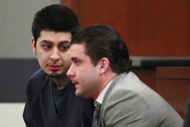 Peter Andrade Jr. talks with his attorney Lance Hendron before his preliminary hearing on attempted murder and other charges Tuesday, April 1, 2014.