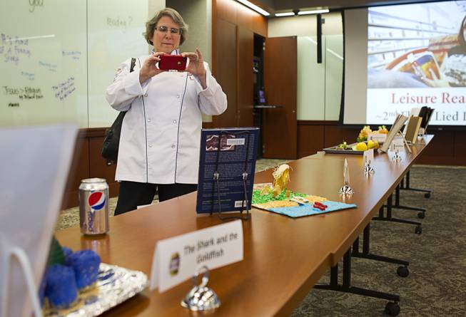 Jean Hertzman, an associate professor in the hotel college, takes a photo of an entry during the 2014 Edible Book Festival at the UNLV Lied Library Tuesday, April 1, 2014. Students were challenged to create edible creations inspired by books.