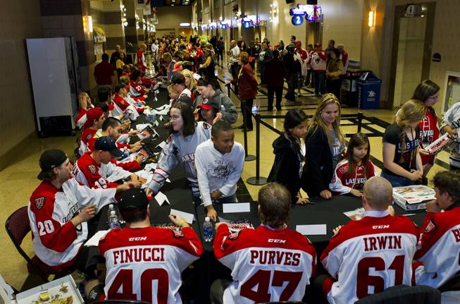 Players with the Las Vegas Wranglers Professional Hockey Club sign autographs for fans after their last home game of the regular season in the Orleans Arena on Tuesday, April 1, 2014.