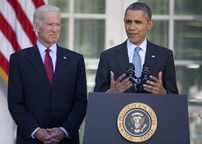 President Barack Obama, with Vice President Joe Biden, speaks in the Rose Garden of the White House in Washington, Tuesday, April 1, 2014, about the Affordable Care Act.