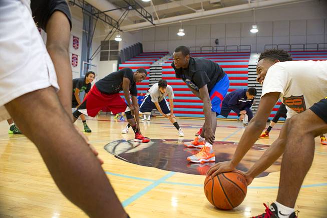 Nick Brannon, center left, and Nate Grimes lead members of the Las Vegas Knicks in stretching during practice at Western High School Wednesday, April 2, 2014. The club team has gone from starting its program to being nationally ranked in three years. Now they have a sponsorship from Reebok.