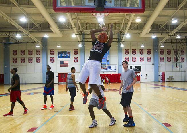 Deon Whiteside dunks the ball during Las Vegas Knicks practice at Western High School Wednesday, April 2, 2014. The Amateur Athletic Union team has gone from starting its program to being nationally ranked in one year. Now they have a sponsorship from Reebok.