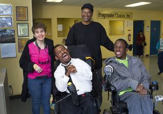 Shawn Jefferson, standing center, poses Tanya Zwick, phone receptionist, Marcus Olige, greeter, and Terrance Woods, greeter-in-training, at the Progressive Choices training center Wednesday, April 2, 2014. The organization helps find employment for people with developmental disabilities.
