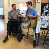 Amputee Eddie Garcia talks with Rudy Garcia-Tolson from the Challenged Athletes Foundation about the new prosthetics he will be receiving Wednesday, April 2, 2014.
