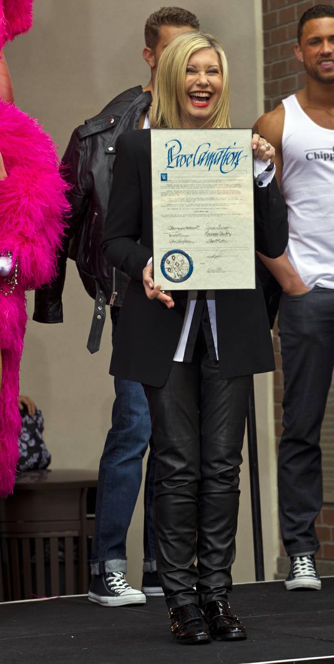 Olivia Newton-John shows off her proclamation as she makes her official Las Vegas arrival to begin her residency Summer Nights at the Flamingo on Wednesday, April 2, 2014.