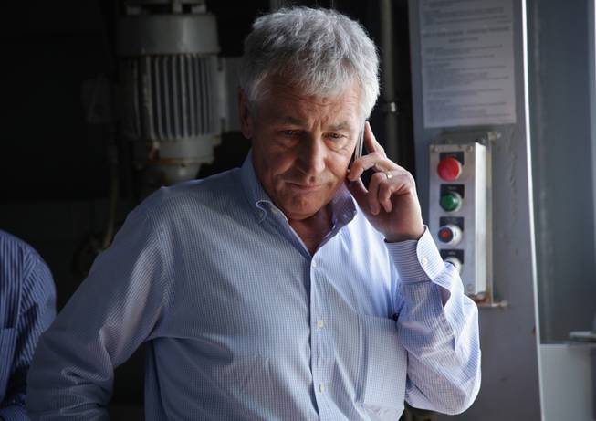 U.S. Secretary of Defense Chuck Hagel receives an update on the phone on the shooting at Fort Hood in Texas, as he was on a tour of the USS Anchorage, an amphibious transport dock ship, with his counterparts from Southeast Asia on Wednesday, April 2, 2014, at Joint Base Pearl Harbor-Hickam in Honolulu, Hawaii.