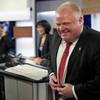 Mayor Rob Ford laughs during a commercial break as he takes part in a live television mayoral debate in Toronto on Wednesday, March 26, 2014. 
