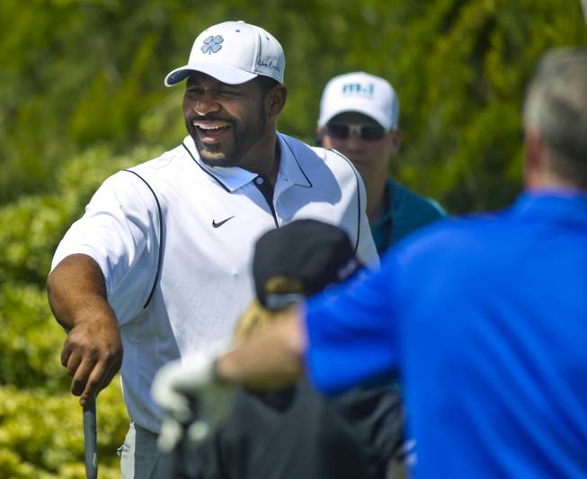 Former NFL player Jerome Bettis laughs with teammates during opening day play of the Michael Jordan Celebrity Invitational at Shadow Creek Golf Course on Thursday, April 3, 2014.