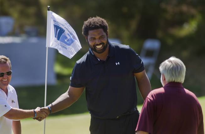 Former NFL player Jonathan Ogden thanks his teammates during opening day play of the Michael Jordan Celebrity Invitational at Shadow Creek Golf Course on Thursday, April 3, 2014.