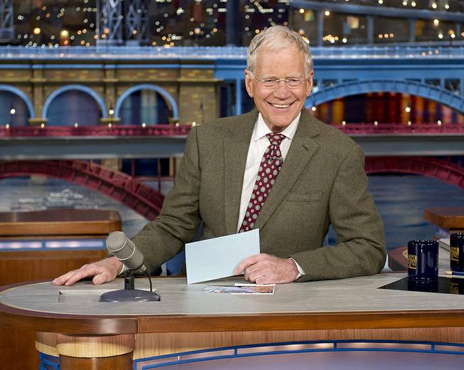 David Letterman, host of the “Late Show with David Letterman,” is seated at his desk in New York on Thursday, April 3, 2014. During taping of the Thursday night telecast, Letterman announced that he will retire in 2015 when his contract expires. 