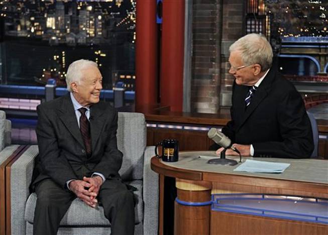 Former President Jimmy Carter, left, talks with David Letterman on "Late Show with David Letterman," Monday March 24, 2014. During a taping of the show Thursday, April 3, 2014, Letterman said he has informed his CBS bosses that he will step down in 2015, when his current contract expires.