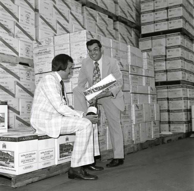 Larry Ruvo and Jerry Vallen look over a bottle of wine at the Southern Wine & Spirits warehouse for the first UNLVino event in 1974.